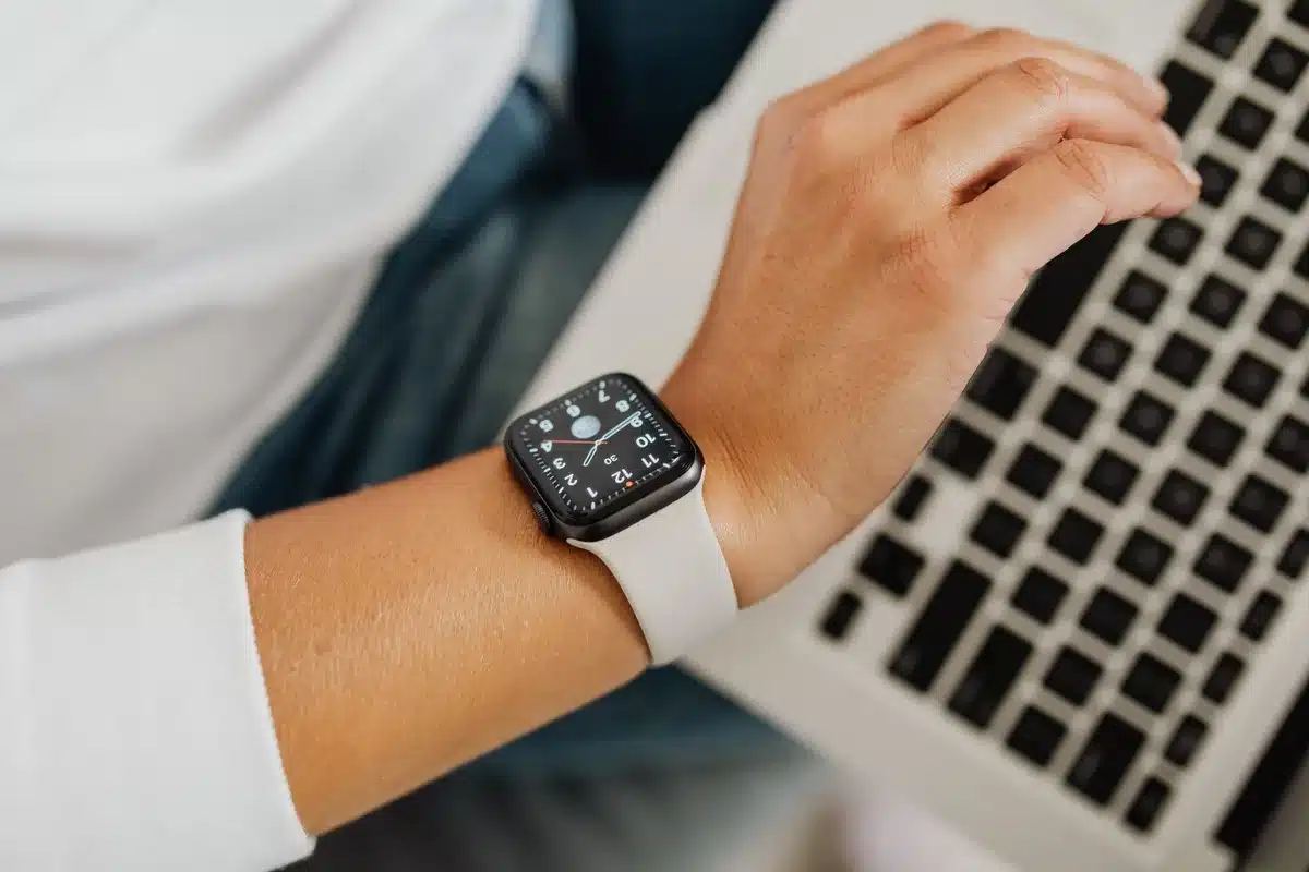 Elegant circular smartwatch display in warm light, premium metal case and digital crown visible, minimalist aesthetic
