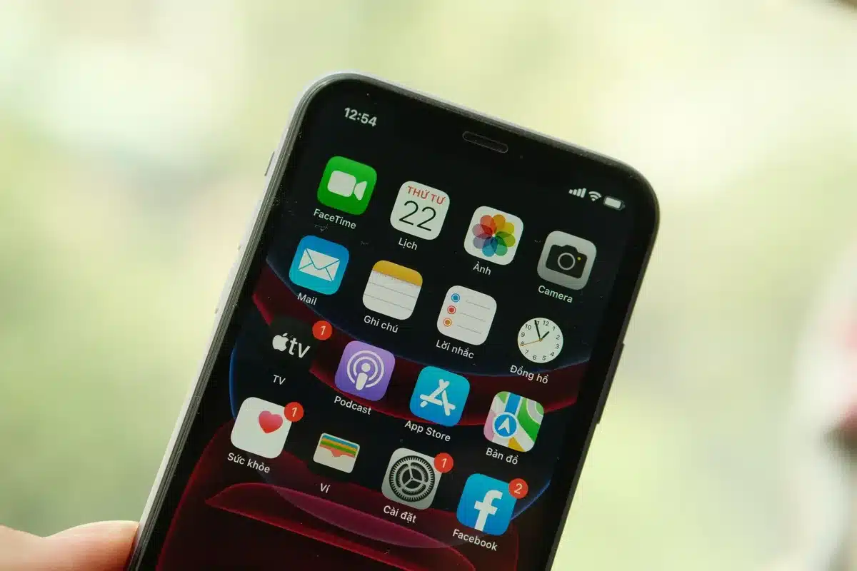 A smartphone screen displaying app icons on a home interface, one icon highlighted with a lock symbol, Face ID scan animation visible, minimalist design aesthetic