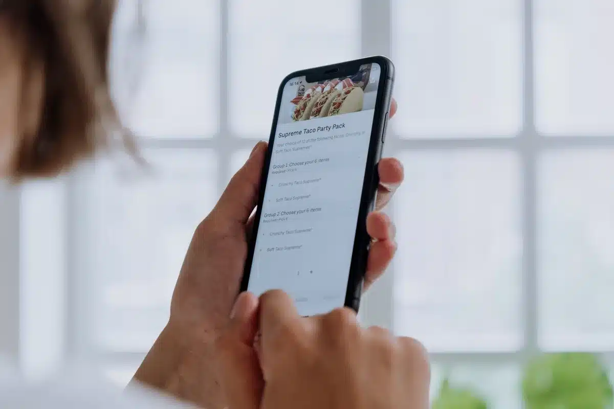 A smartphone screen displaying real-time translation interface with two languages side by side, showing live conversation transcription with highlighted translated text.