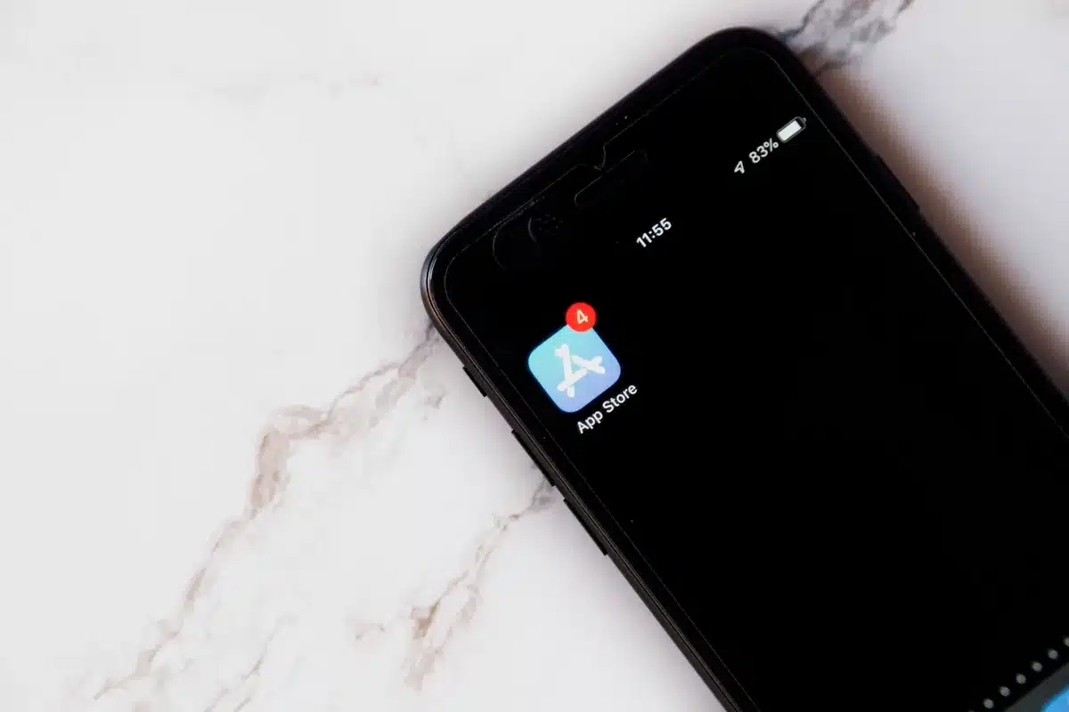 Close-up of an anonymous smartphone screen showing an update progress bar, hand in soft focus nearby