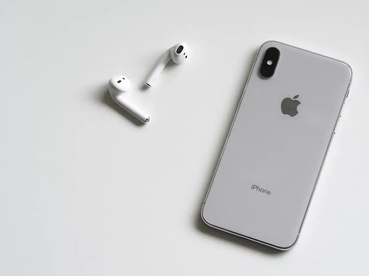 An anonymous close-up of an empty smartphone display on a desk next to scattered SIM removal tools, no branding visible
