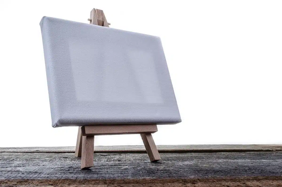 empty studio stand with single spotlight and a coiled cable on wooden floor