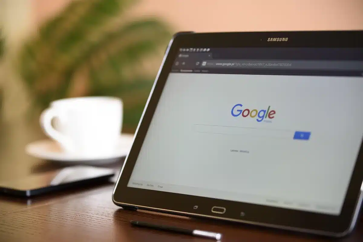 Close-up of anonymous hands holding a cellphone showing a WiFi icon, soft-focus home interior behind