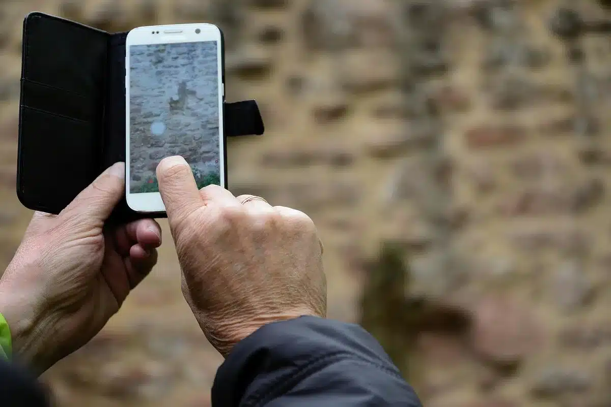 Close-up of an unbranded smartphone screen with irregular brightness bands and a visible notification bar anomaly, no logos visible