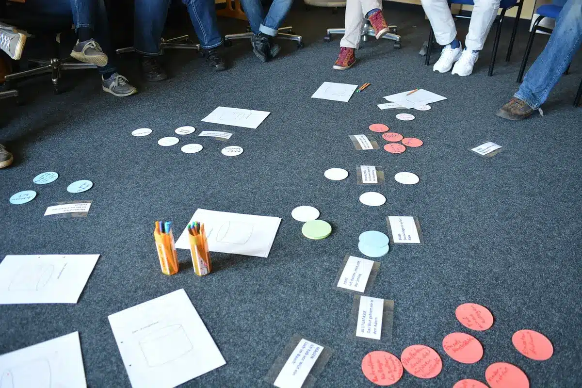 A symbolic training classroom with anonymous adults at desks using tablets, a generic company logo-free banner blurred on the wall