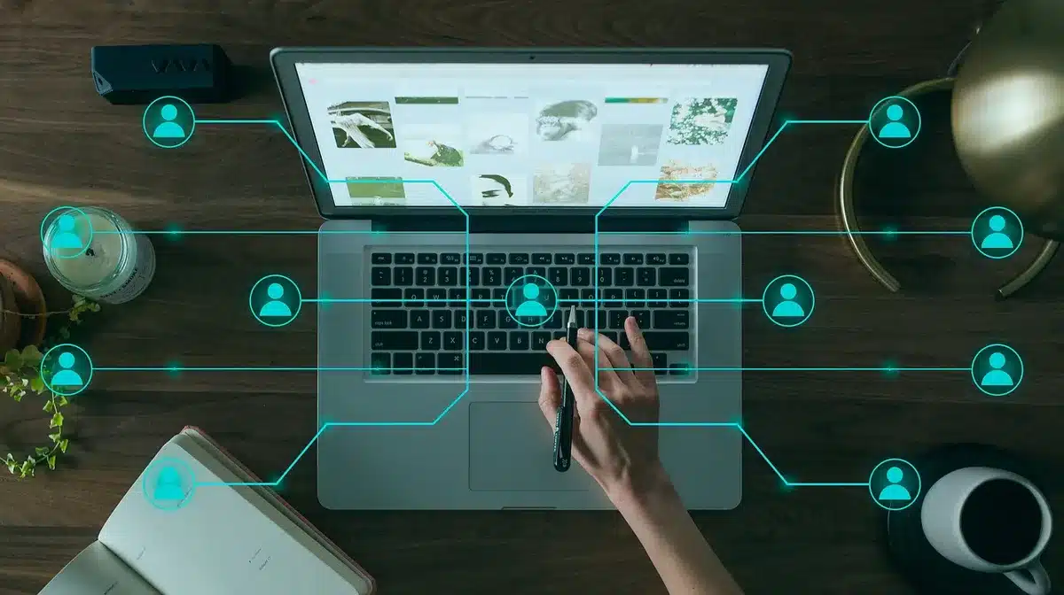 Close-up of anonymous hands holding a credit card and smartphone on a table, subscription page blurred on screen, decision moment