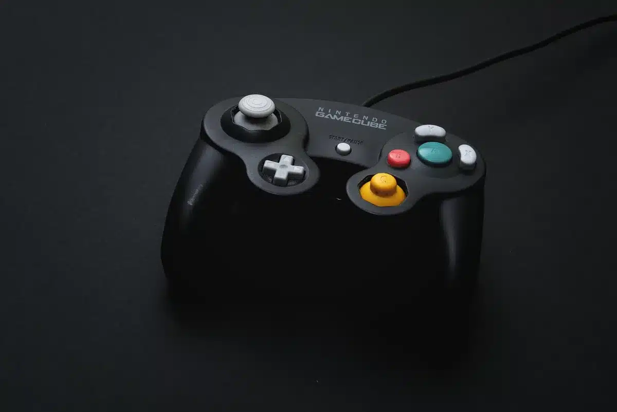 Close-up of anonymous hands holding a Joy-Con near a screen showing mission selection