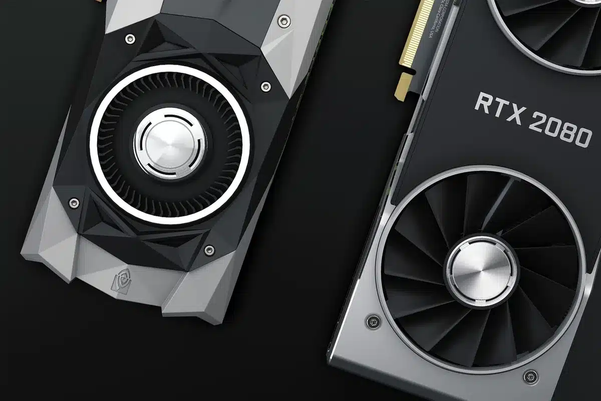 Close-up of an unbranded GPU resting beside a screwdriver and thermal paste on a workbench, no logos visible