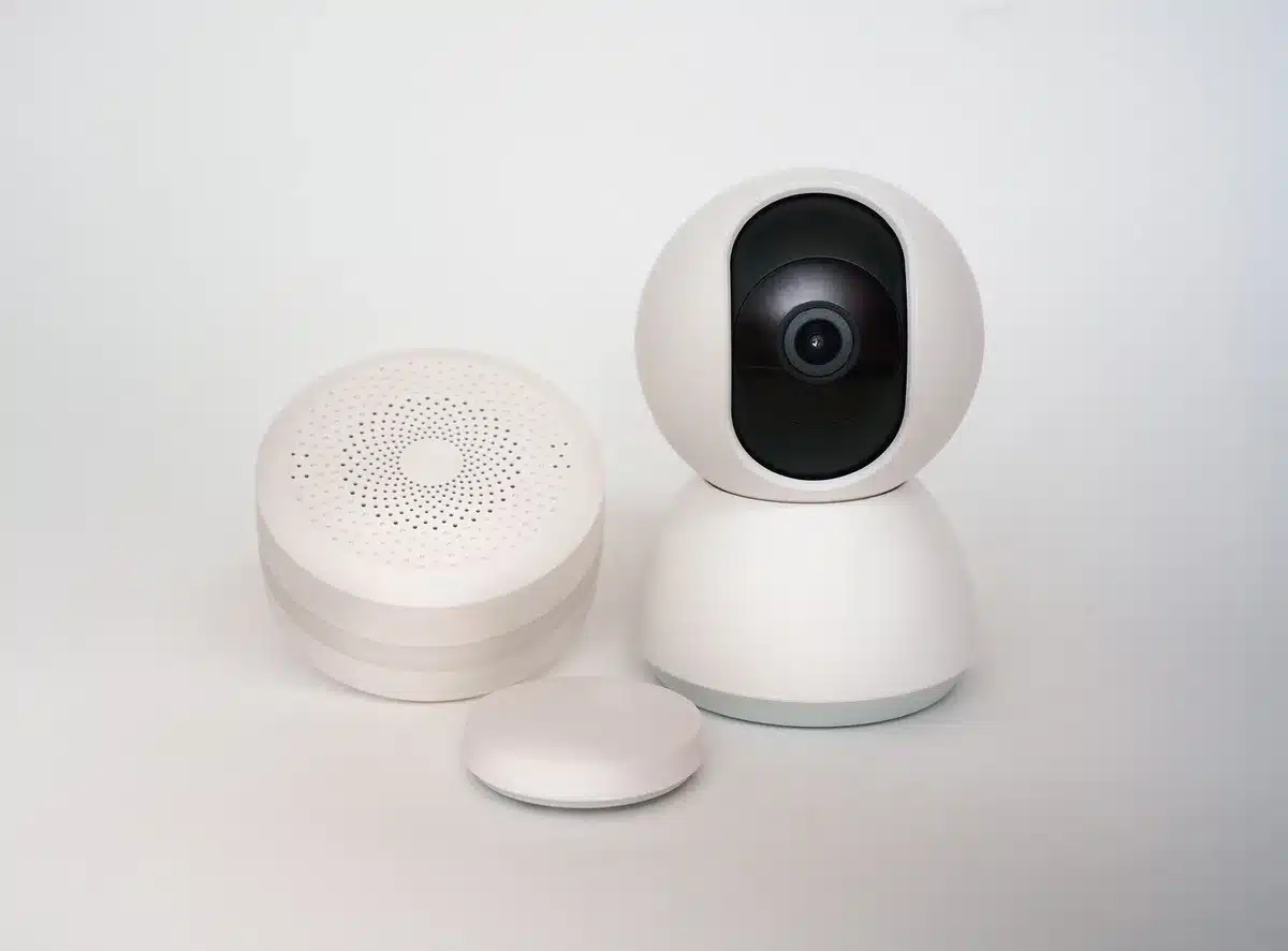 empty smart living room with an unbranded small speaker and a black set-top box on a shelf, soft daylight through a window